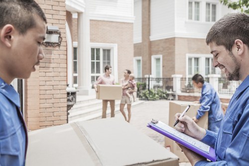 Movers handling a flat relocation in Surrey with careful packing and stair access