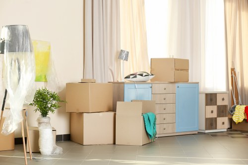 A local moving team handling a Surrey home relocation with boxes and furniture