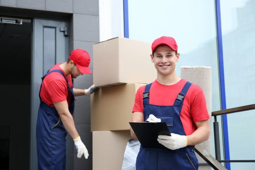 Trained moving staff using proper lifting techniques during a Surrey relocation
