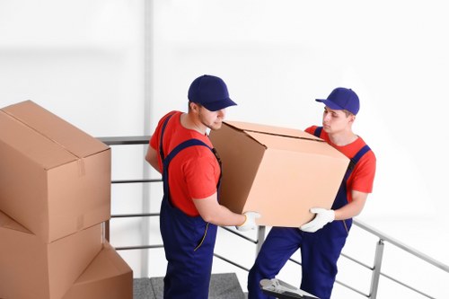 Removal team planning a Surrey house move with boxes and furniture